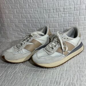 New Balance 237 sneaker in a white and beige/tan colorway